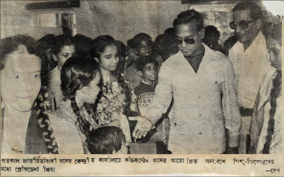 A newspaper cutting: a man in dark glasses and a light jacket walking among a group of girls and young people indoors