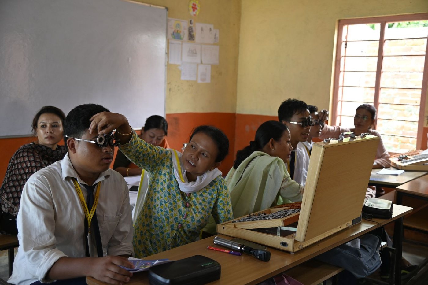 A child’s eyesight being checked in a classroom