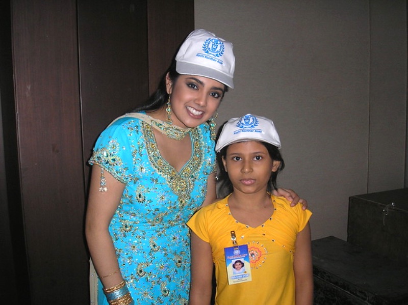 Volunteer and child wearing Kochi Konther Asar caps
