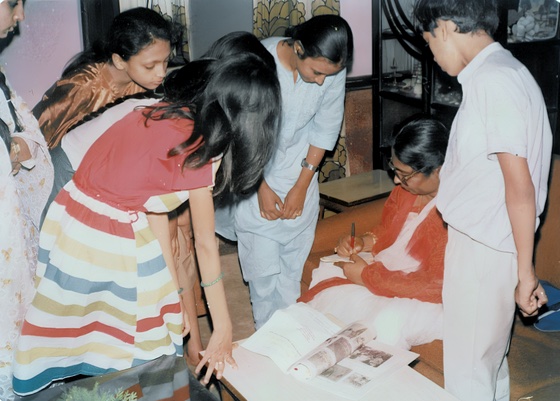 A volunteer handing over a donation box